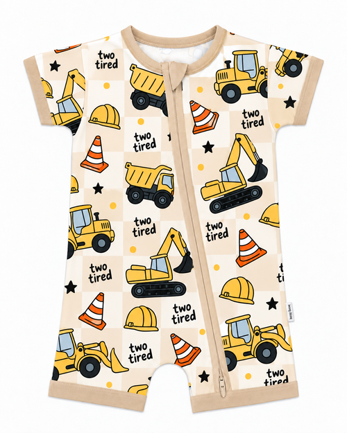 Two Tired Construction long sleeve bamboo zippy with yellow dump trucks and excavators on a cream checkerboard print