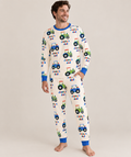 Dad in cream bamboo pajamas printed with blue and green tractors and his child's name, royal blue ribbed trim