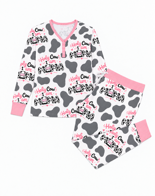 Flat lay of Holy Cow I'm Mama bamboo pajama set: long-sleeve henley with pink button placket and jogger pants in grey cow spots with pink waistband