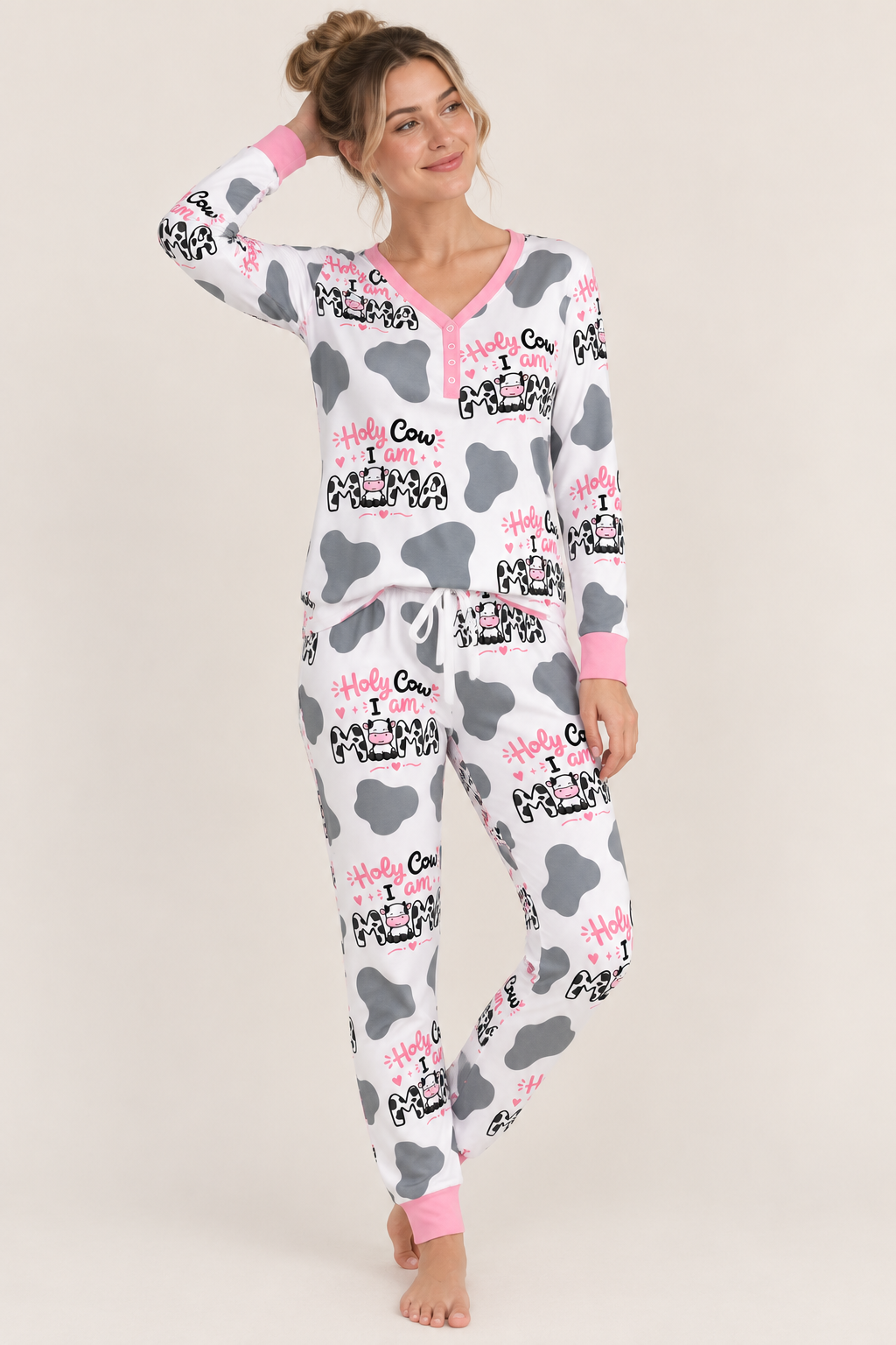Woman wearing Holy Cow I'm Mama women's bamboo pajamas: white cow print henley top and joggers with Holy Cow I am MAMA lettering and pink cuffs