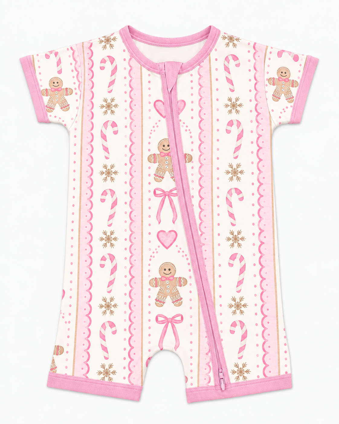 Flat lay of a short sleeve pink gingerbread bamboo romper with pink two-way zipper, bows, hearts and scalloped ribbon stripes on cream.
