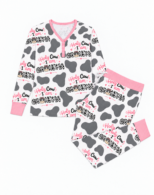 Flat lay of the Holy Cow I'm Grandma women's bamboo pajama set, a V-neck henley top and joggers in grey cow print with pink trim