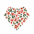 Christmas Leopard bamboo bandana bib laid flat, with red, green and gold leopard spots on cream and a cream bound neckline