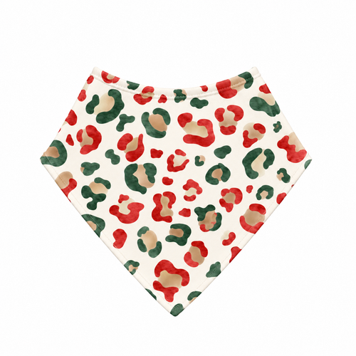 Christmas Leopard bamboo bandana bib laid flat, with red, green and gold leopard spots on cream and a cream bound neckline