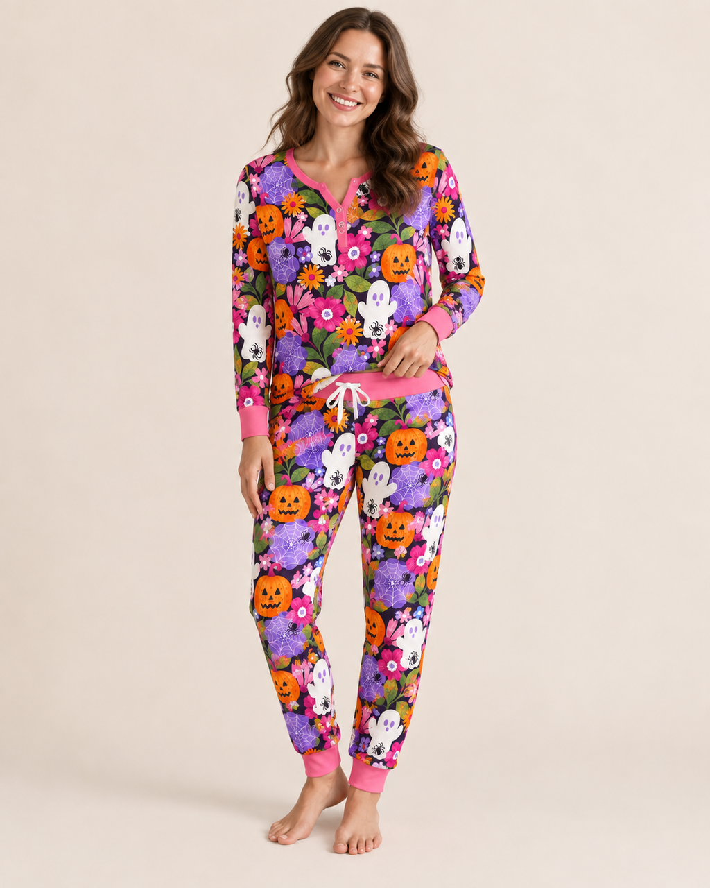 Woman wearing the Pumpkin Garden women's bamboo pajama set — long-sleeve button-front top and pants in a purple pumpkin and ghost print