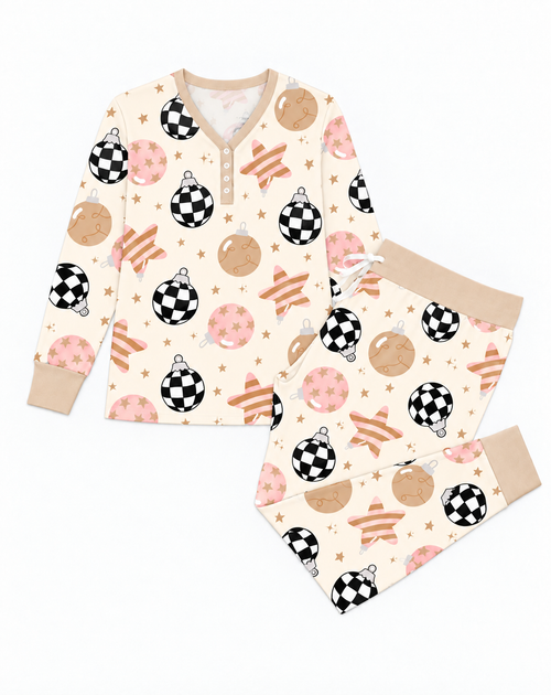 Flat lay of the Merry & Bright long sleeve bamboo pajama top and jogger pants with tan ribbed cuffs, in cream Christmas ornament print